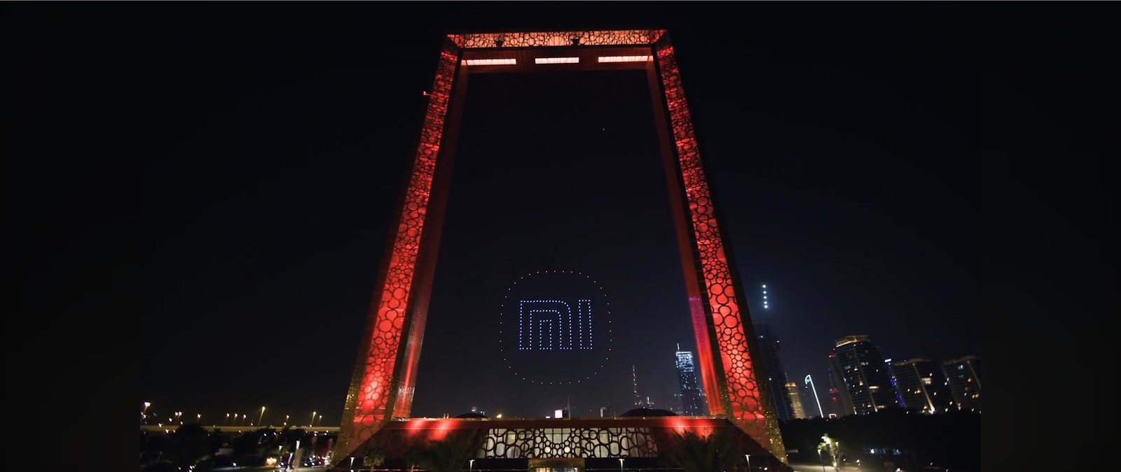 Drone light show over a city skyline at night